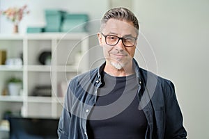 Portrait of happy older casual man at home smiling