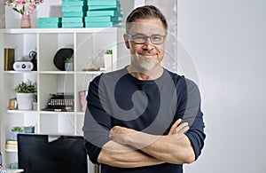 Portrait of happy older casual man at home smiling