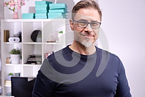 Portrait of happy older casual man at home smiling