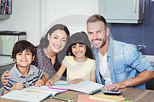 Portrait of happy parents assisting children