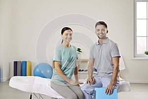 Portrait of happy patient with professional chiropractor, osteopath, masseur or physiotherapist