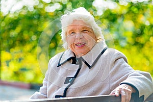 Portrait of happy pensioner sitting on a bench