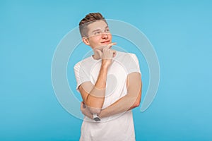 Portrait of happy pensive man in casual white t-shirt looking up with peaceful meditative expression