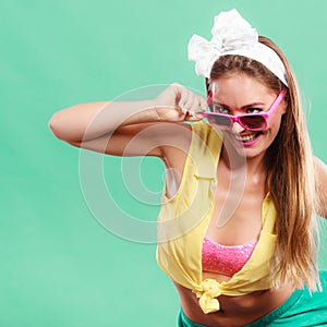 Portrait of happy pin up girl wearing sunglasses.