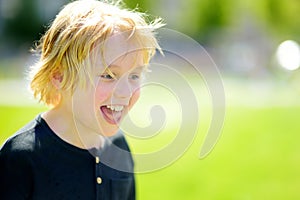 Portrait of happy preteen boy during walks on sunny summer day