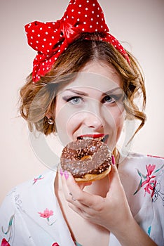Portrait of happy pretty girl beautiful blond young woman with excellent dental care teeth having fun eating donut