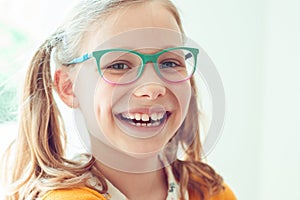 Portrait of happy pretty smiling teen girl in glasses