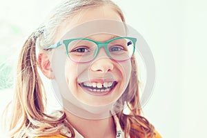 Portrait of happy pretty smiling teen girl in glasses
