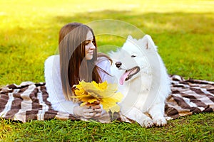 Portrait happy pretty woman and white Samoyed dog having fun