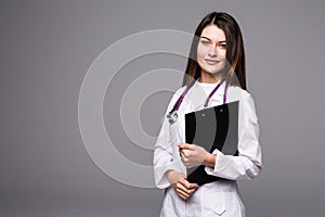 Portrait of happy pretty young woman doctor with clipboard and stethoscope over white background