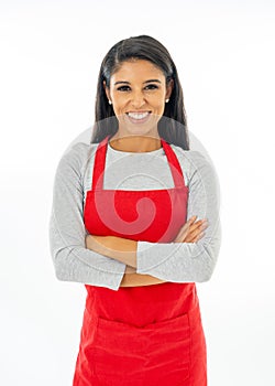 Portrait of a happy proud beautiful latin woman wearing a red apron learning to cook making thumb up gesture in cooking classes