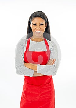 Portrait of a happy proud beautiful latin woman wearing a red apron learning to cook making thumb up gesture in cooking classes