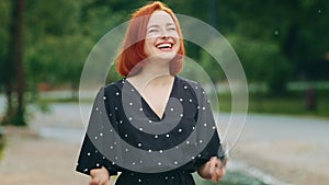 Portrait of happy redhead young woman successful girl look at mobile phone outdoors surprised caucasian teenage user