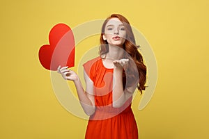 Portrait of happy romantic young caucasian girl with red paper heart-shaped postcard, romantic wishes, Valentine day