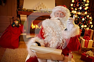 Portrait of happy Santa Claus with wish list