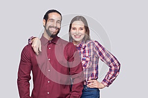 Portrait of happy satisfied bearded man and woman in casual style standing and looking at camera with toothy smile