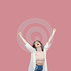 Portrait of happy satisfied beautiful brunette young woman with curly hairstyle in casual style standing, screaming and