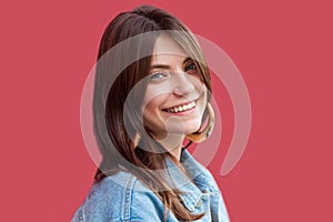 Portrait of happy satisfied beautiful brunette young woman with makeup in denim casual style standing and looking at camera with