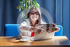 Portrait of happy satisfied beautiful stylish brunette young woman in glasses sitting and hug her favorite laptop with love and