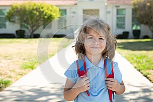 Portrait of happy school kid is going to school for the first time. Child boy with bag go to elementary school. Child of