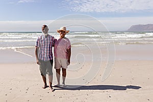 Portrait of happy senior african american couple standing on the beach