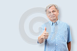 Portrait of happy senior asian man gesture hand showing thumb up or good sign and looking at camera