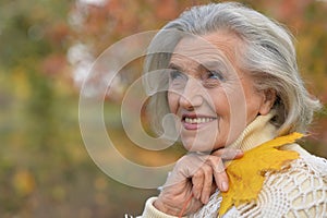 Portrait of happy senior beautiful woman in park