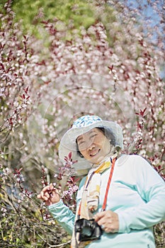 Portrait of happy senior beautiful woman in spring park