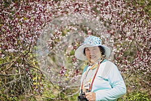 Portrait of happy senior beautiful woman in spring park