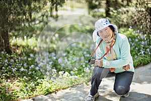 Portrait of happy senior beautiful woman in spring park