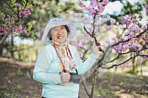 Portrait of happy senior beautiful woman in spring park