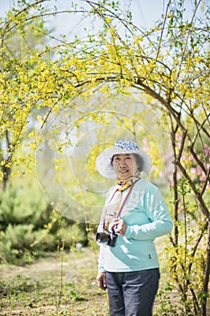 Portrait of happy senior beautiful woman in spring park