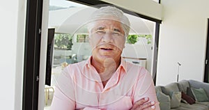 Portrait of happy senior biracial man at retirement home