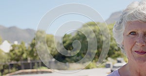 Portrait of happy senior caucasian woman in sunny garden, unaltered, in slow motion, copy space