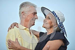 Portrait of happy senior couple embracing outdoors