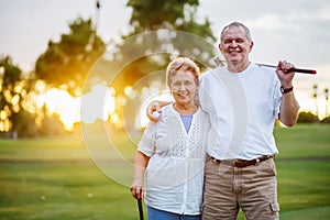 Portrait of happy senior couple enjoying active lifestyle playing golf