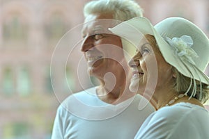 Portrait of happy senior couple at hotel resort posing