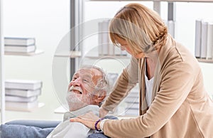 Portrait of happy senior couple in living room, Elderly man and woman relaxing on cozy sofa at home, Happy family concepts