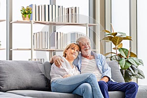 Portrait of happy senior couple in living room, Elderly woman and a man relaxing on cozy sofa at home, Happy family concepts