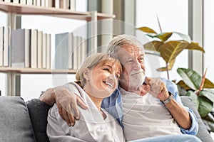 Portrait of happy senior couple in living room, Elderly woman and a man relaxing on cozy sofa at home, Happy family concepts