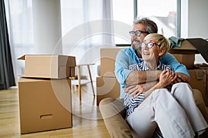 Portrait of happy senior couple in love moving in new home