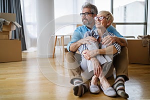 Portrait of happy senior couple in love moving in new home