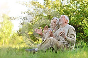 Portrait of a happy senior couple sitting outdoors