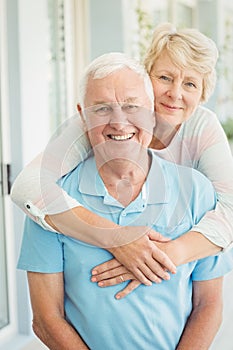 Portrait of happy senior couple smiling while hugging