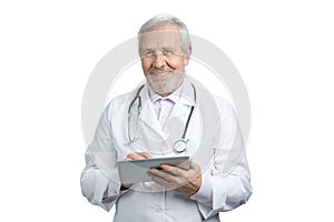 Portrait of happy senior doctor with tablet.