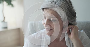 Portrait of a happy senior elderly woman in a bright comfortable apartment.