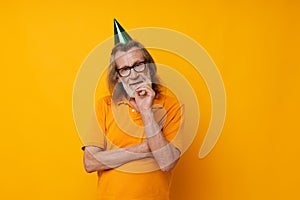 Portrait of happy senior man fun birthday cap on the head monochrome shot