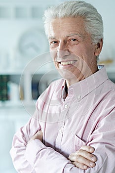 Portrait of happy senior man at home
