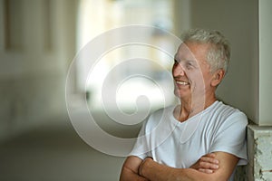 Portrait of happy senior man at home