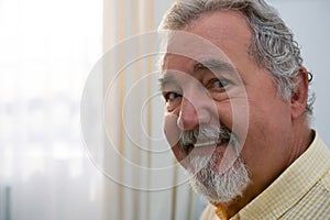 Portrait of happy senior man in retirement home